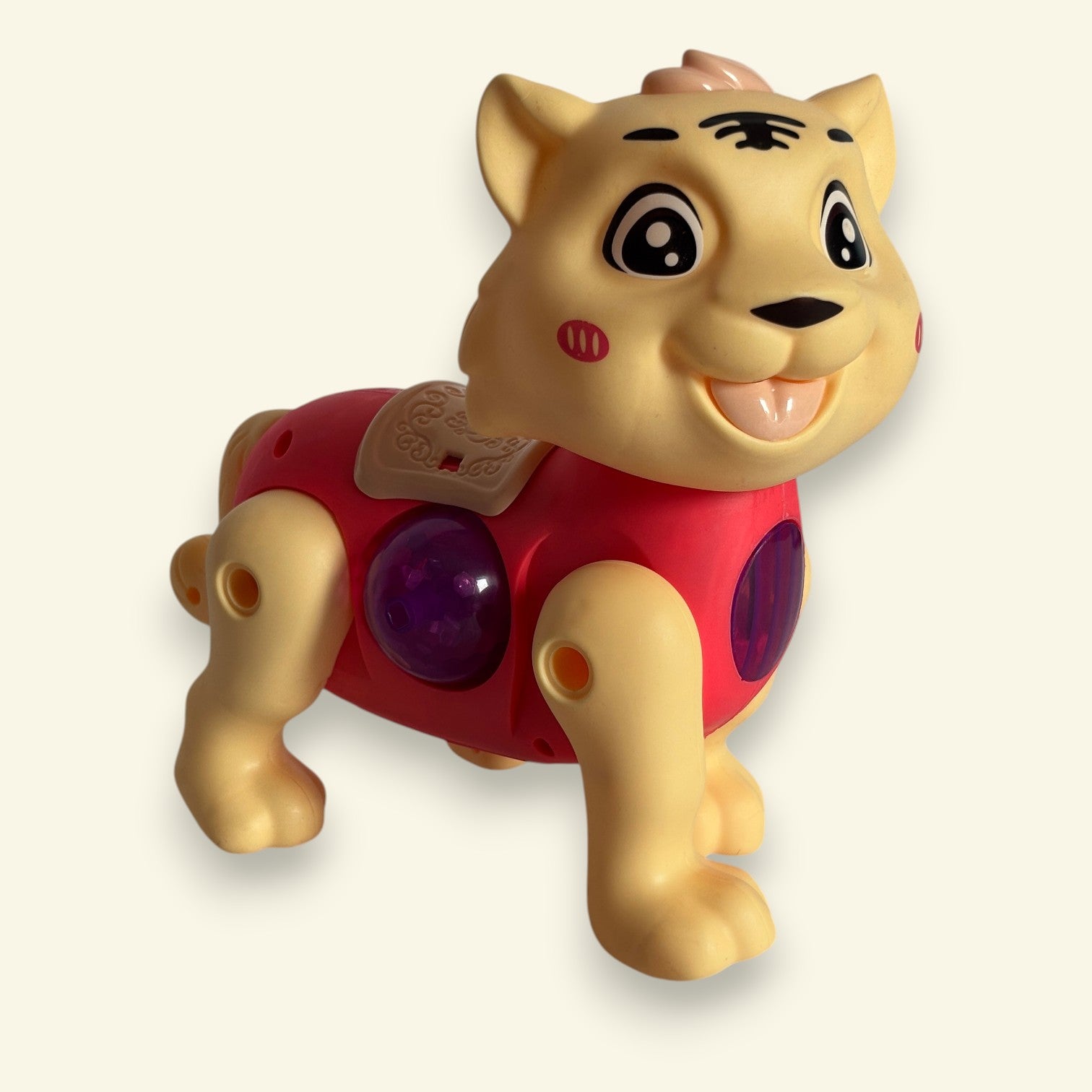 Toy tiger with a red chest and purple ball on a beige background